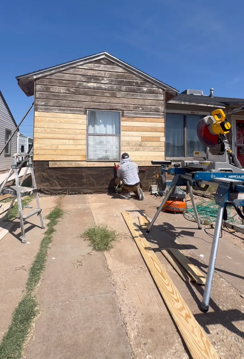 A house mid-restoration, new siding going up